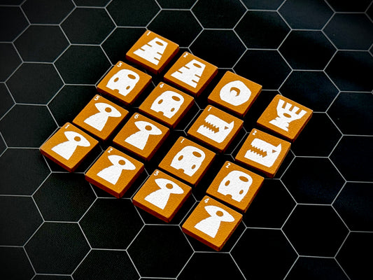 Yellow QuoDrox tiles showing the front designs on a black hex map.
