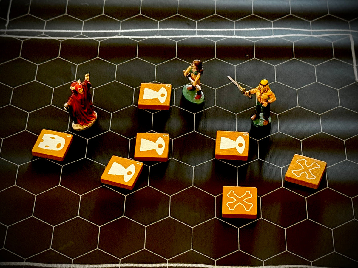 Hex mat with three miniature figure and several yellow QuoDrox tiles.