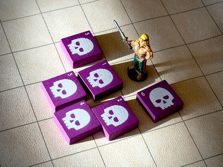 A barbarian miniature figures surrounded by purple QuoDrox tiles with skull icons. All on a beige hex gaming mat. 