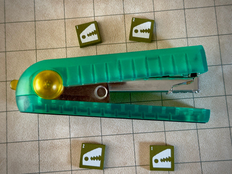 four gratorr quodrox tiles around a stapler