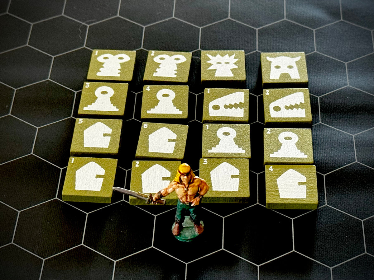 Green QuoDrox tiles showing the front designs on a black hex map.  A miniature figure stands in the front. 
