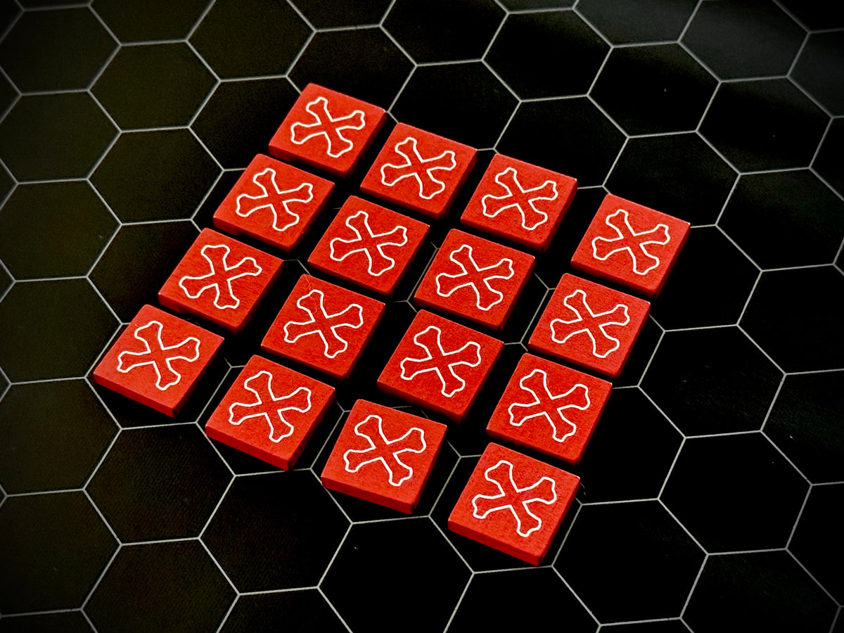 Red QuoDrox tiles showing the crossbones on the back on a black hex map. 