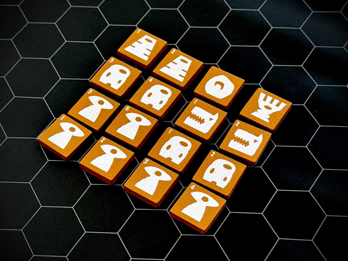 Yellow QuoDrox tiles showing the front designs on a black hex map. 