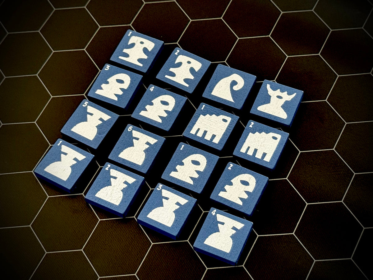 Blue QuoDrox tiles showing the front designs on a black hex map. 