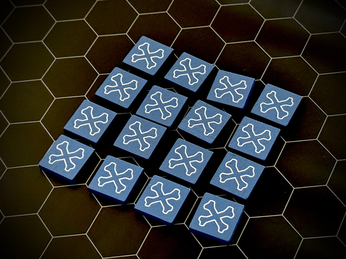 Blue QuoDrox tiles showing the crossbones on the back on a black hex map. 
