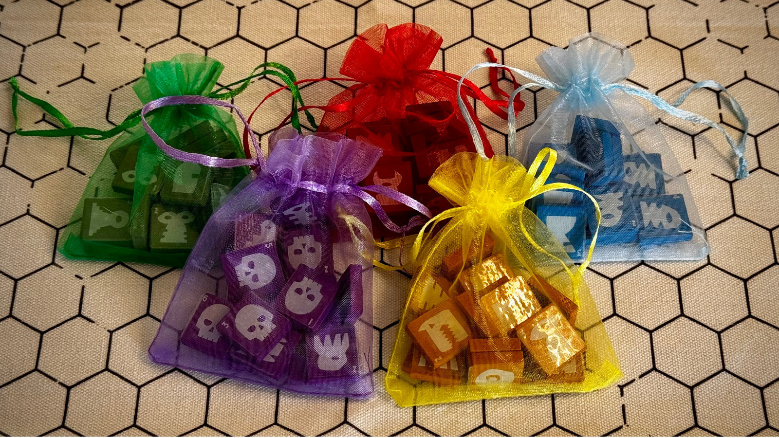 Four colorful organza bags of QuoDrox tiles