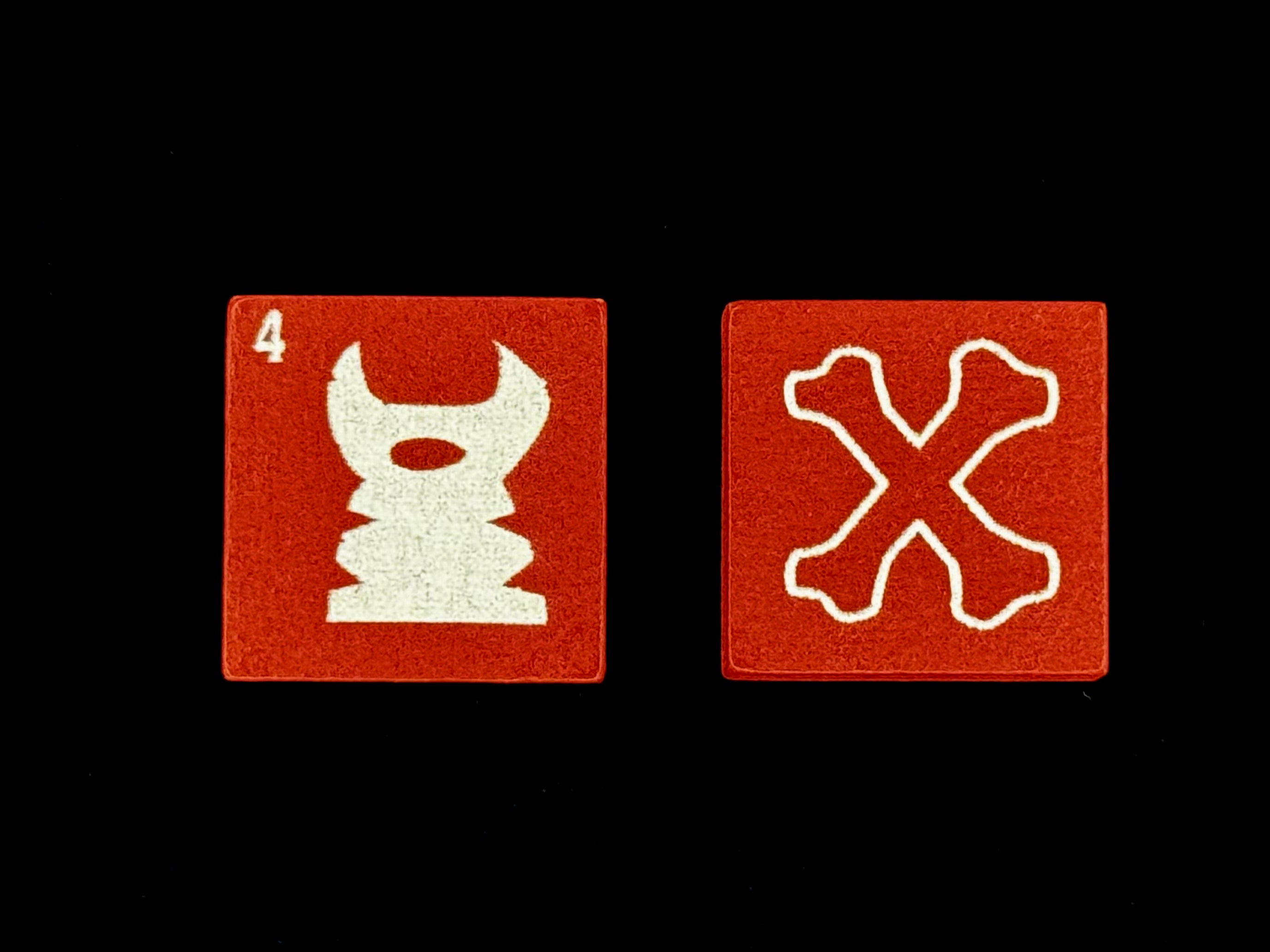 Two purple QuoDrox tiles showing skull and crossbones sides