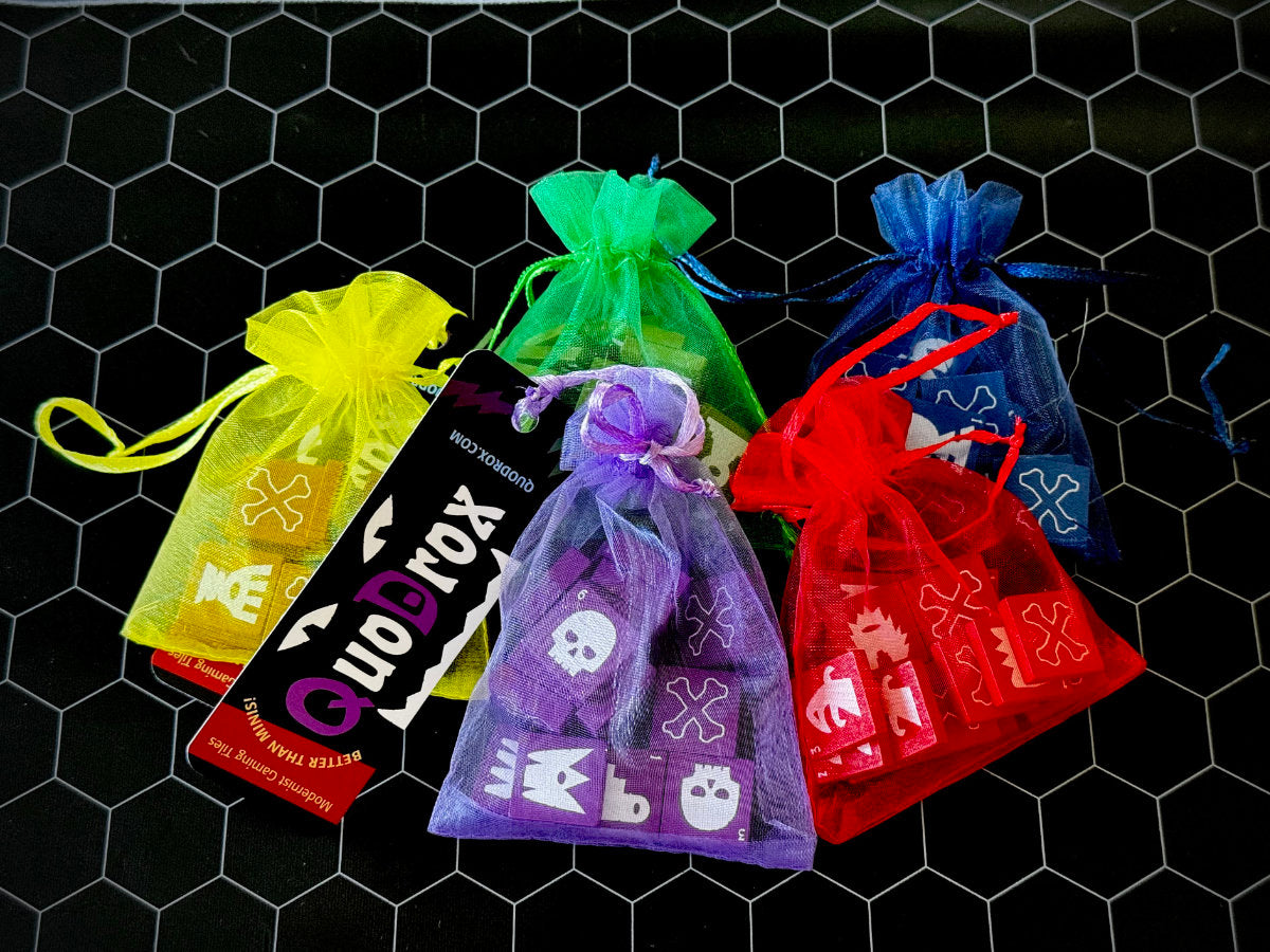 Four colorful organza bags of QuoDrox tiles