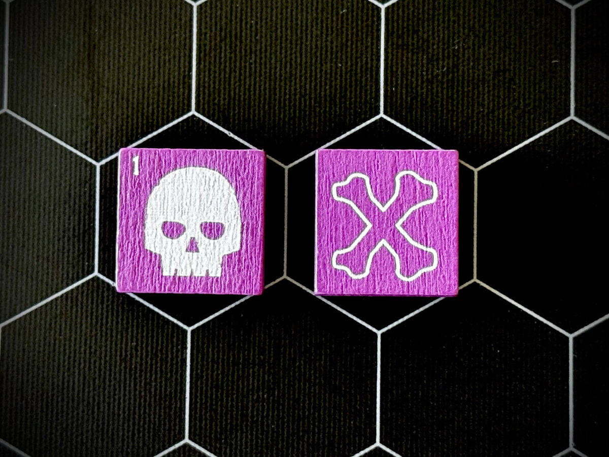 Two purple QuoDrox tiles showing skull and crossbones sides